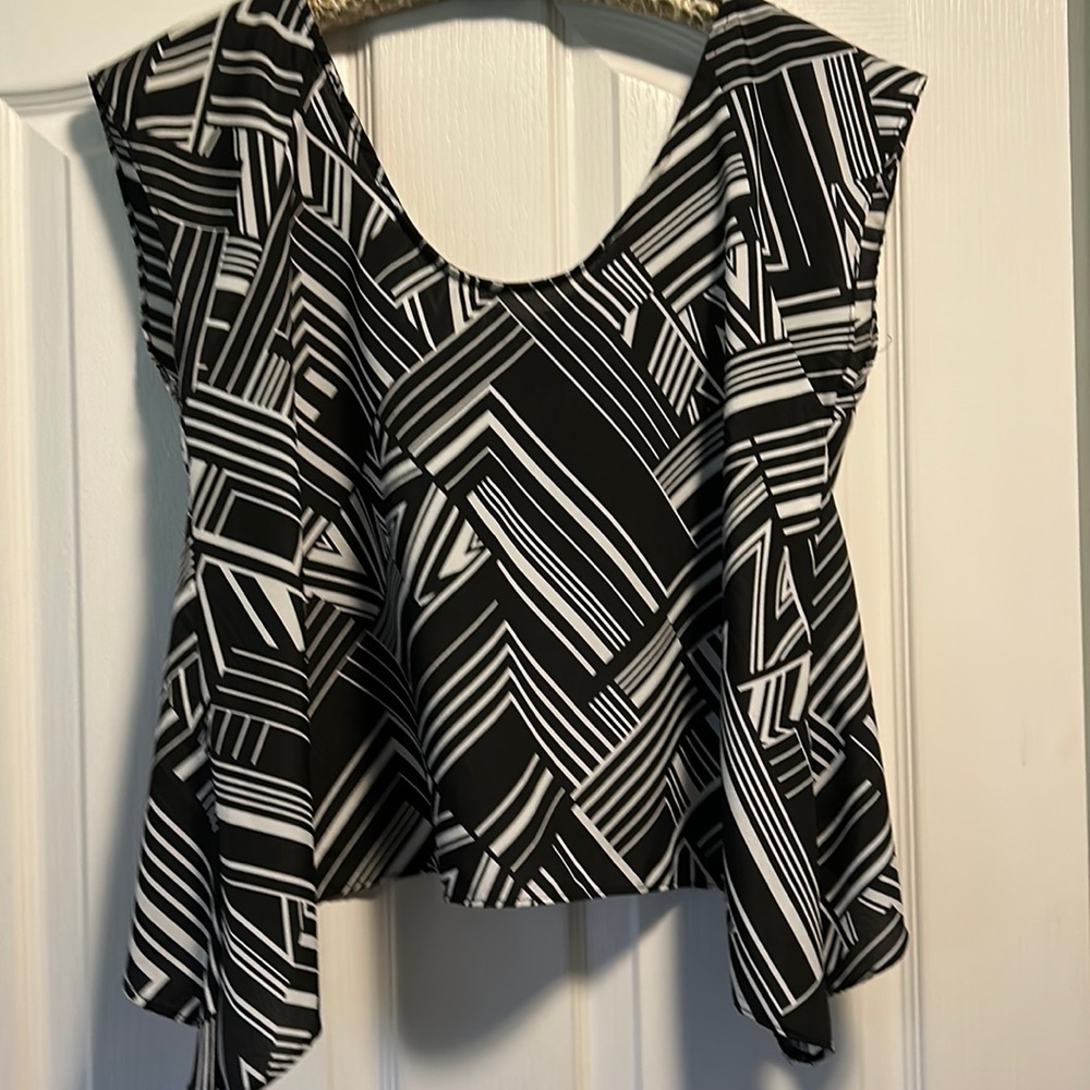 Women top.100% polyester. Open in the back.